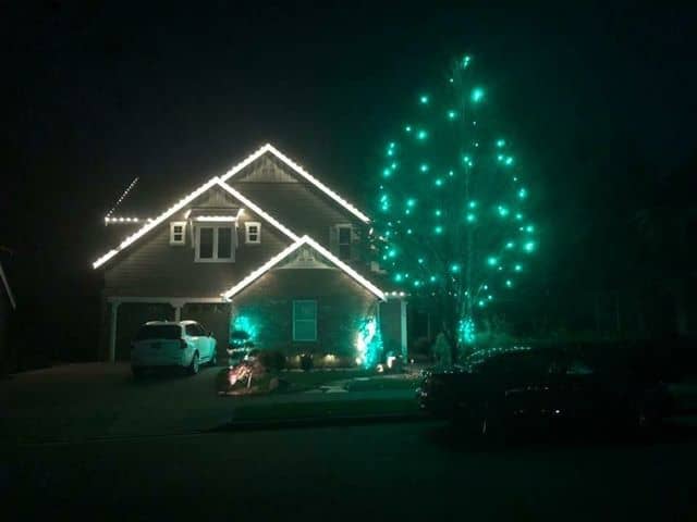 Tree and house with lighting and cars or also there